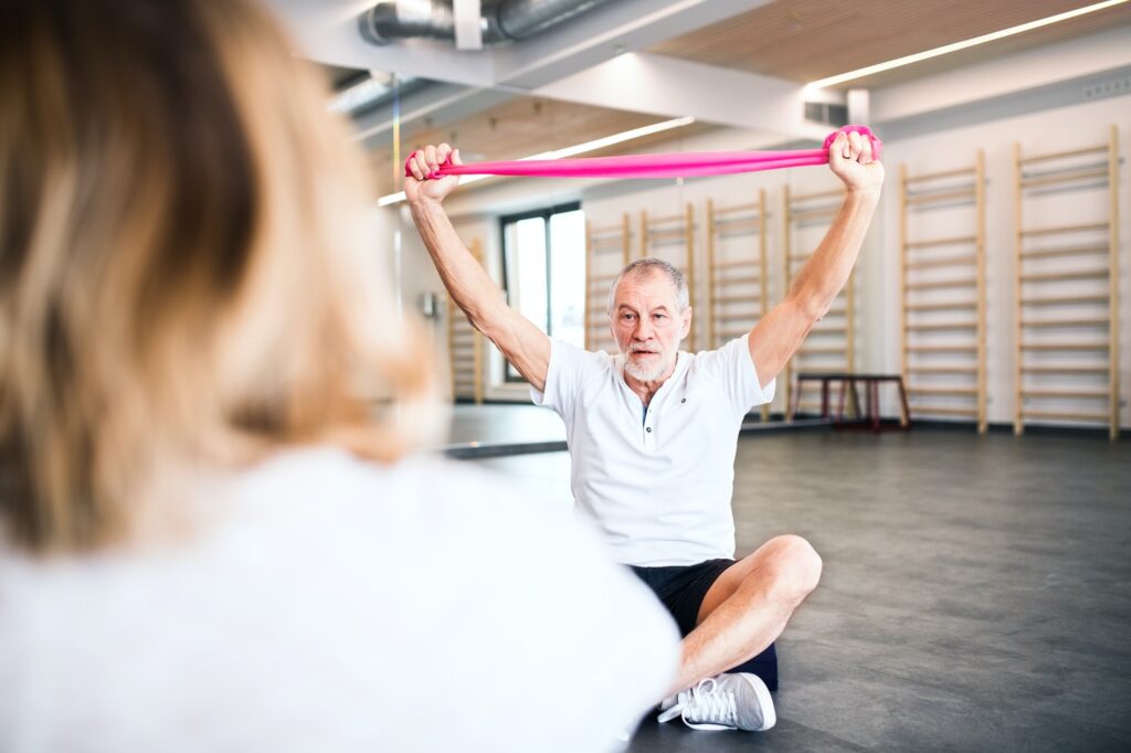 Senior physiotherapist working with a female patient.